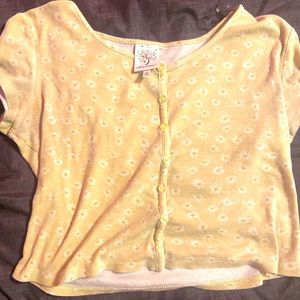a yellow cropped button down shirt